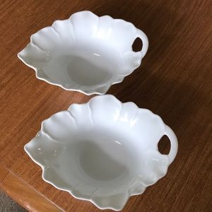 A pair of white bowls with handles